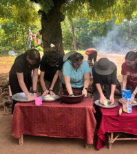 Ciara and friends make dinner at the camp
